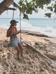 Woman swinging on beach swing
